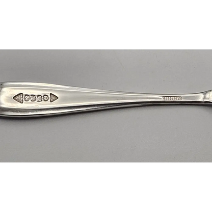 Silver spoon on a gray background