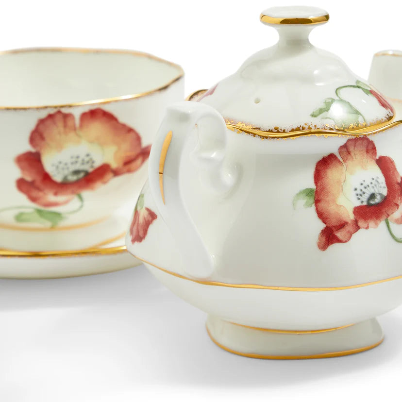 White teapot with floral design and gold trim on a white background