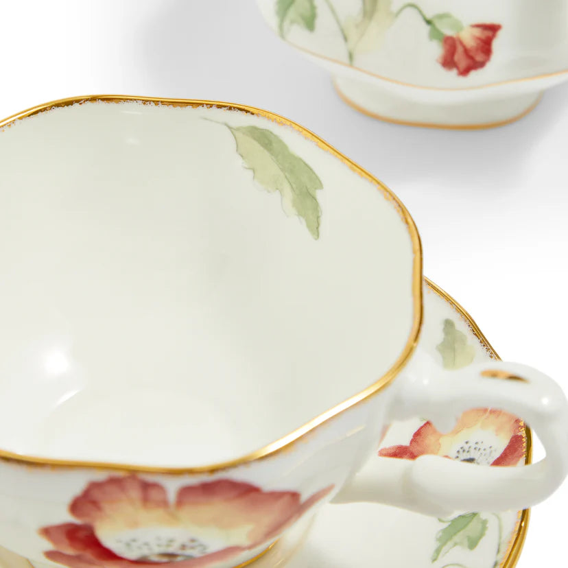 Teacup with floral design and gold trim on a white background