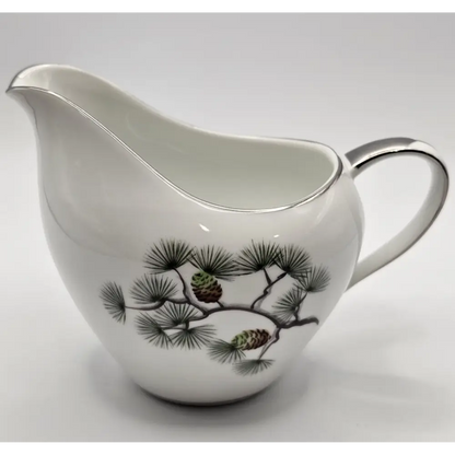 White ceramic pitcher with pine branch design