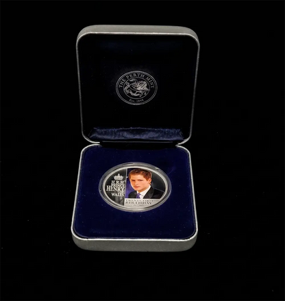 A commemorative silver coin presented in an open dark blue velvet box with a silver border, photographed against a solid black background. The coin features a portrait of John Henry Wilkes and the text 'JOHN HENRY WILKES' and 'MERRY END'.