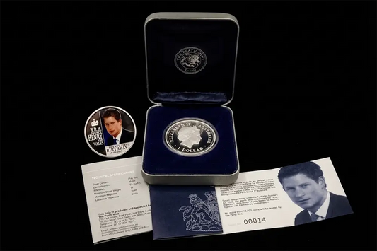 A silver commemorative coin presented in an open dark blue velvet box, with a matching round coin, printed cards, and a black background. The coin and packaging feature portraits of British Prime Minister Winston Churchill from our World & Vintage Coins collection