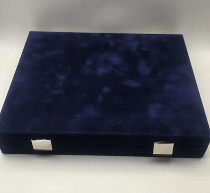 Navy blue velvet jewelry box with silver corners on a white background