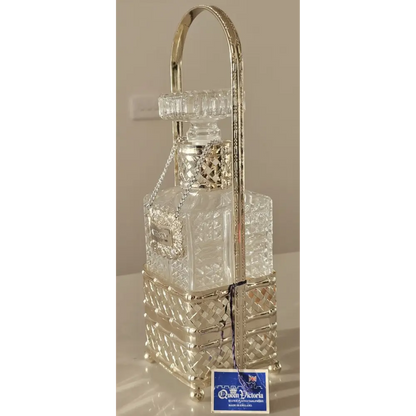 The vintage Queen Victoria whisky decanter displayed on a luxury dark wood bar cart.