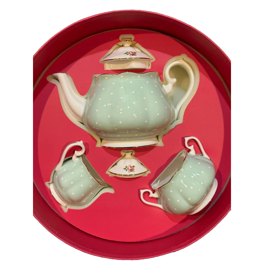 Ceramic teapot set with matching cups and saucers in a red box