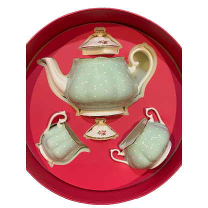 Ceramic teapot set with matching cups and saucers in a red box