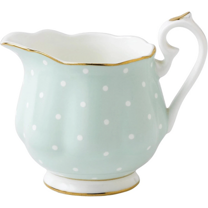 Porcelain creamer with white polka dots and gold accents 