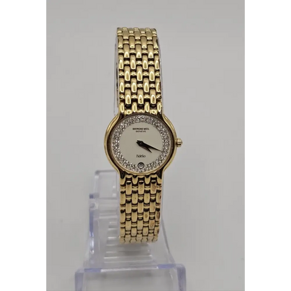 Gold wristwatch with a clear stand 