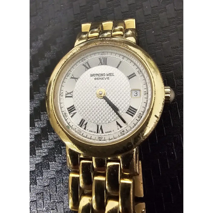 Gold watch with white face and Roman numerals 