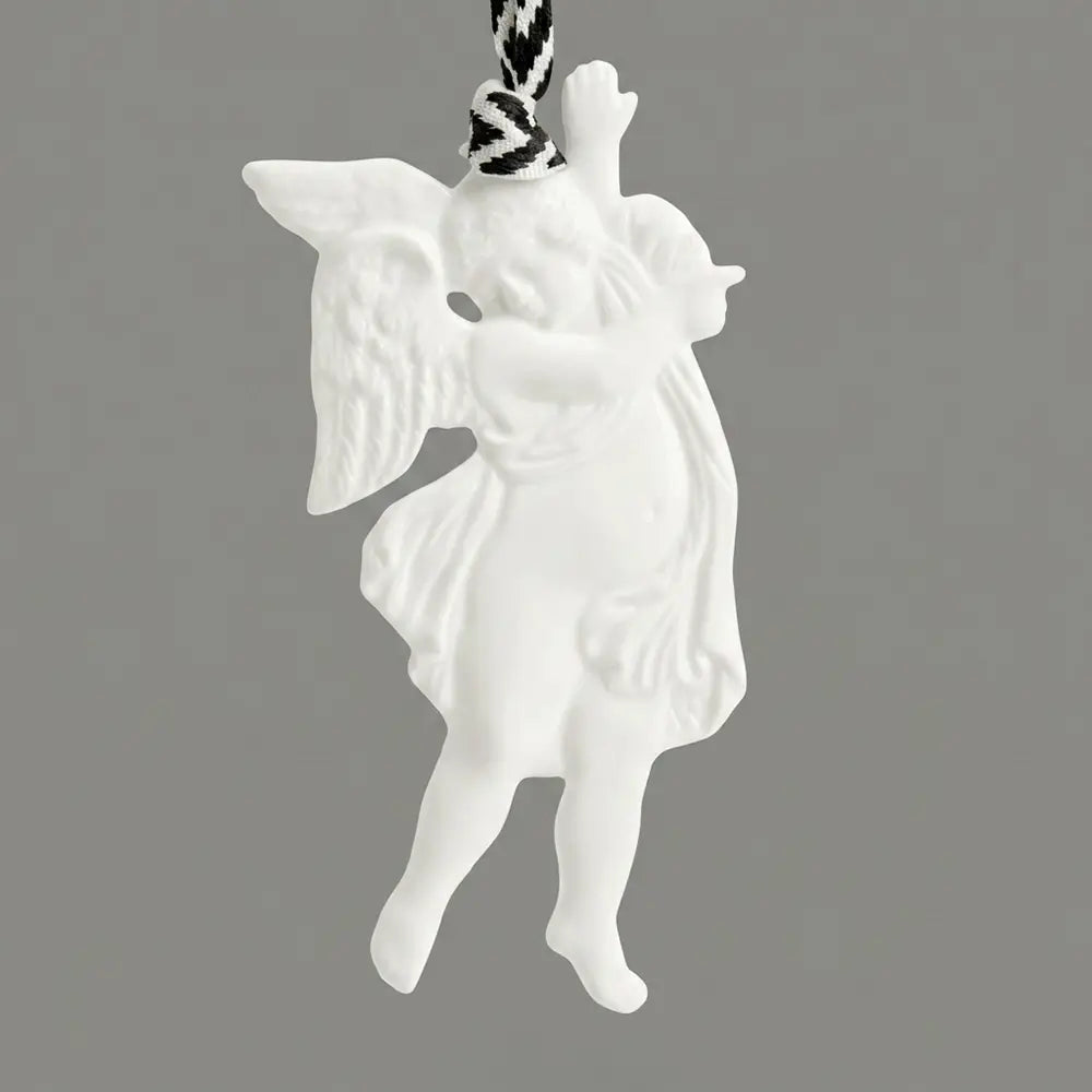 White angel ornament on a gray background