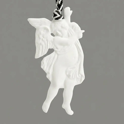 White angel ornament on a gray background