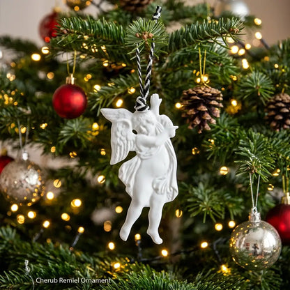 White cherub ornament on a decorated Christmas tree with lights and ornaments.
