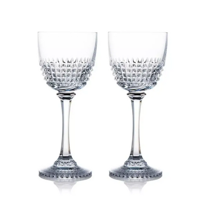 Two crystal wine glasses with intricate designs