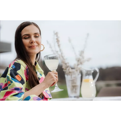 Woman holding a glass of white wine 