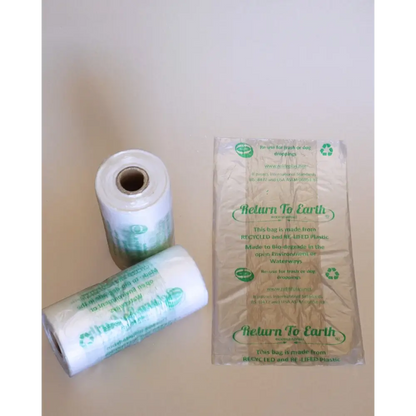 Two rolls of 'Return To Earth' paper on a plain background