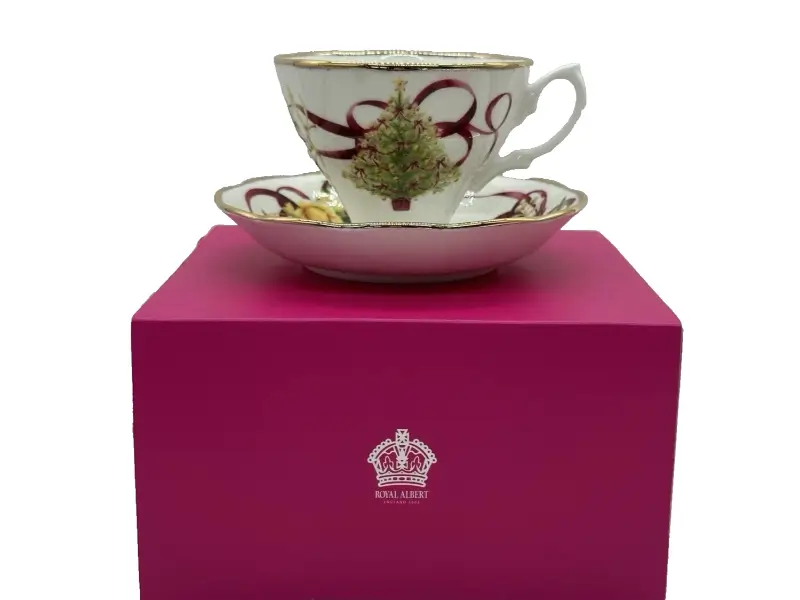 Teacup with decorative design on a pink box featuring Royal Albert logo