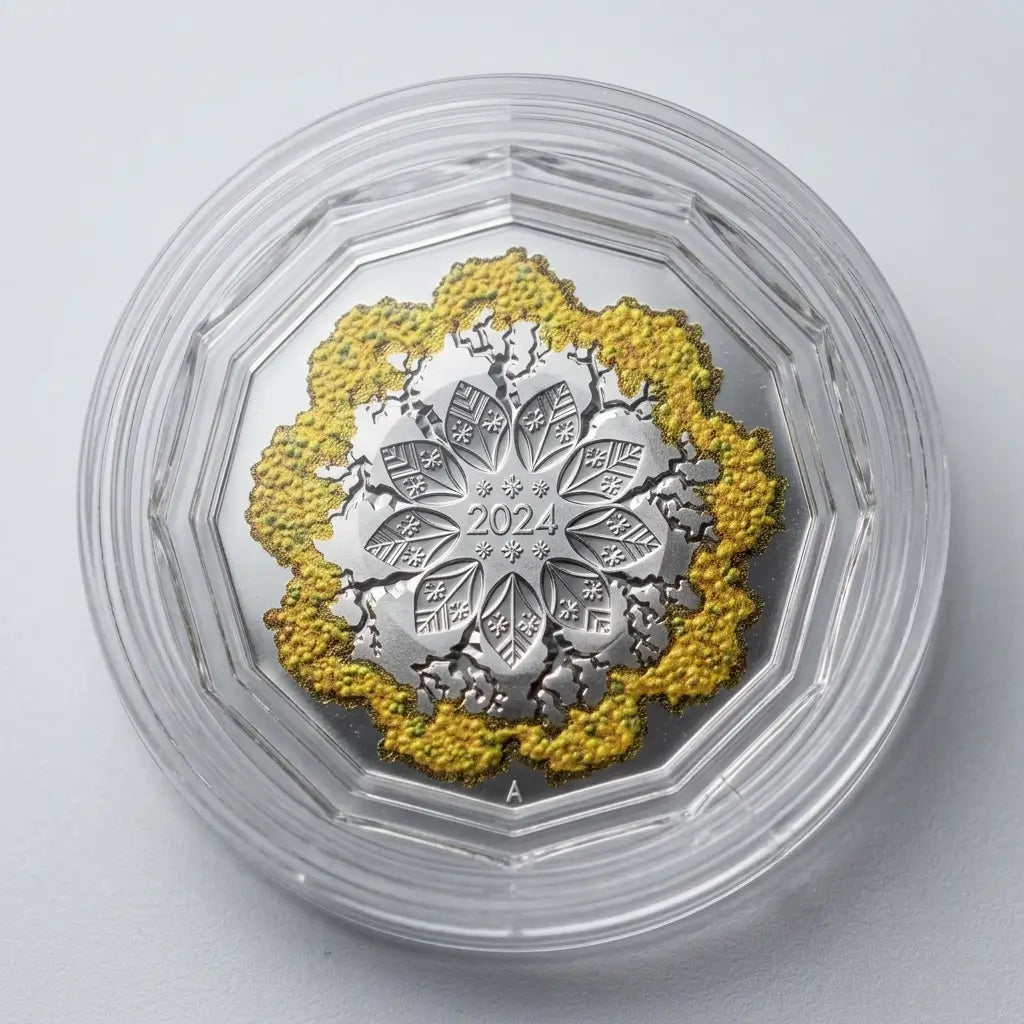 A circular silver medallion with a detailed floral and tree motif, featuring textured yellow-gold detailing around the outer ring, housed inside a clear protective plastic capsule on a light gray background from our World & Vintage Coins collection 