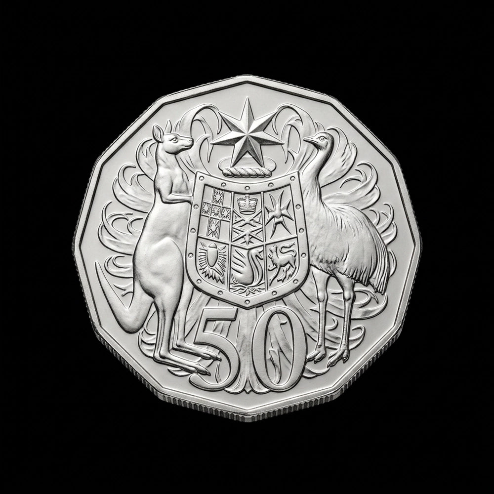 A silver-colored Australian 50 cents coin featuring a kangaroo, emu, and coat of arms, shown against a solid black background.