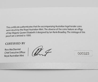 A close-up of a white certificate card from the Royal Australian Mint with printed text, a signature, and the number 000323.