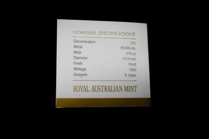 A small white card with gold text reading 'NOMINAL SPECIFICATIONS' and 'ROYAL AUSTRALIAN MINT', photographed against a black background.