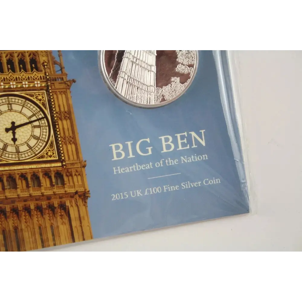 Silver coin in a display case with Big Ben illustration and text