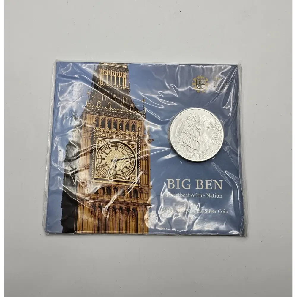 Silver coin in packaging with Big Ben design on a gray background