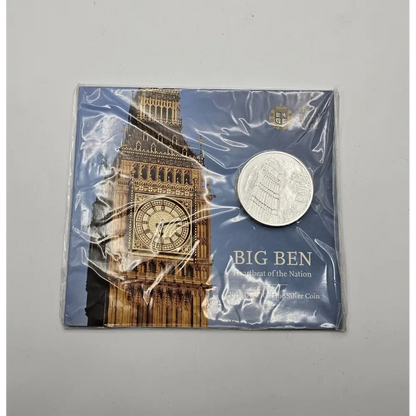 Silver coin in packaging with Big Ben design on a gray background
