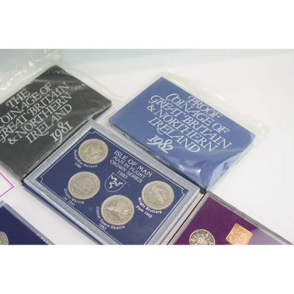 Collection of coin sets from Great Britain and Northern Ireland with protective packaging.