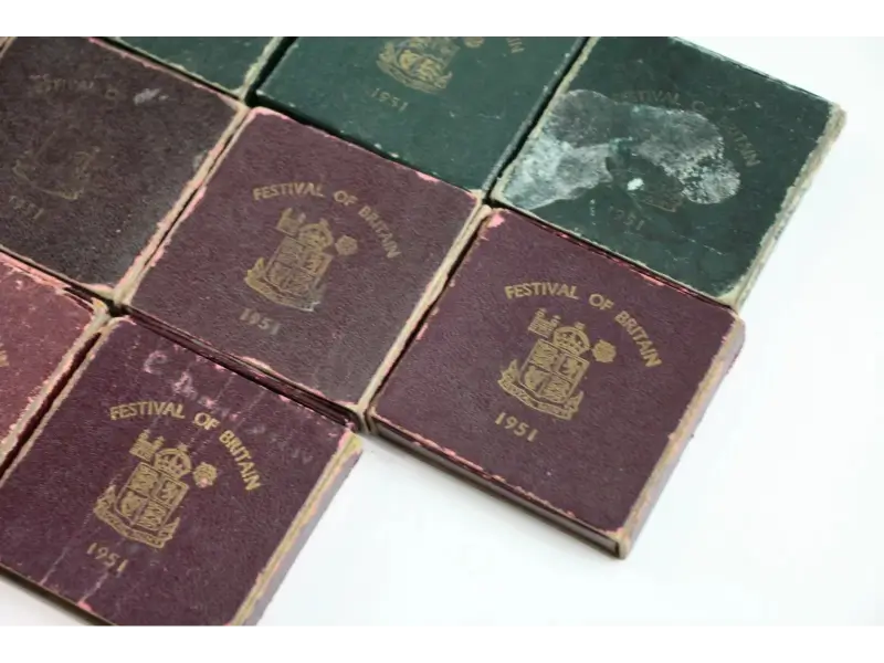 Collection of vintage coins with 'Festival of Britain 1951' embossed on the cover.