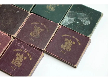 Collection of vintage coins with 'Festival of Britain 1951' embossed on the cover.