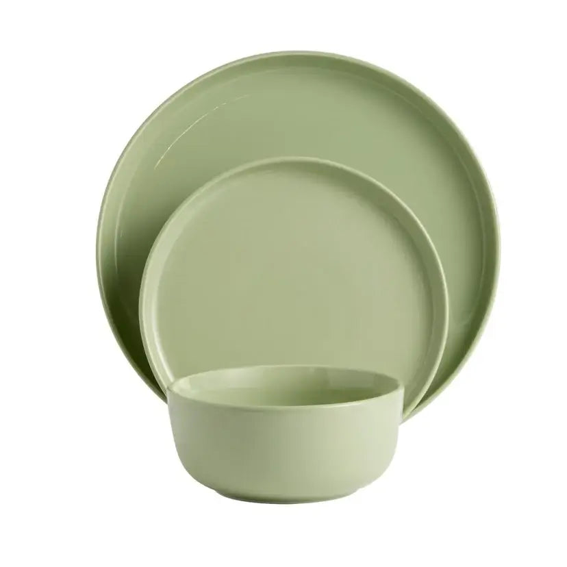 Green ceramic dinnerware set on a white background