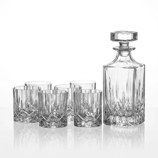A clear cut-crystal decanter with a matching stopper and five matching lowball glasses, arranged on a reflective white surface against a white background from our Royal Doulton Outlet Australia collection