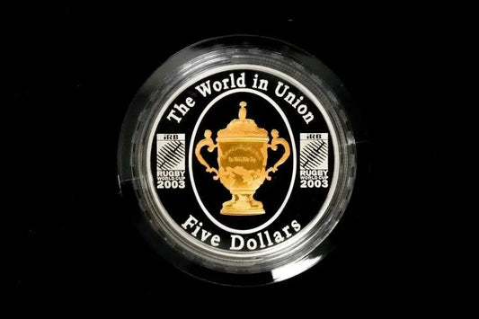 A circular black and gold Rugby 2003 five-dollar coin featuring the World in Union trophy emblem, encased in a clear protective plastic capsule from our World & Vintage Coins collection 