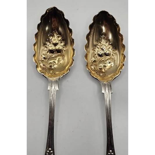 Two ornate spoons with gold detailing