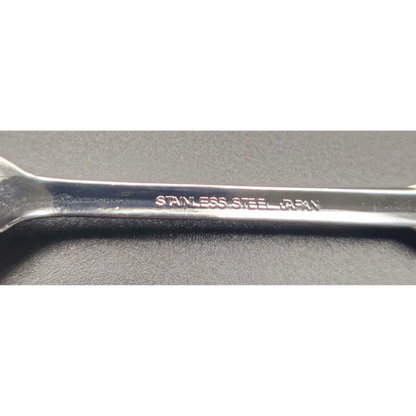 Metal wrench with 'Stainless Steel' engraving on a gray background