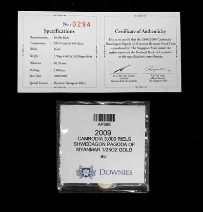 A packaged 2009 Cambodia 3,000 Riels proof coin displayed in a clear plastic case with a white label, shown below two white certificate documents on a black background. The Downies brand is visible on the lower package label.