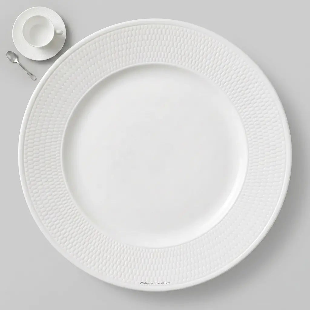 Professional studio shot of a 20.5 cm Wedgwood Gio side plate showing the intricate honeycomb intaglio pattern on the rim and a smooth white finish.