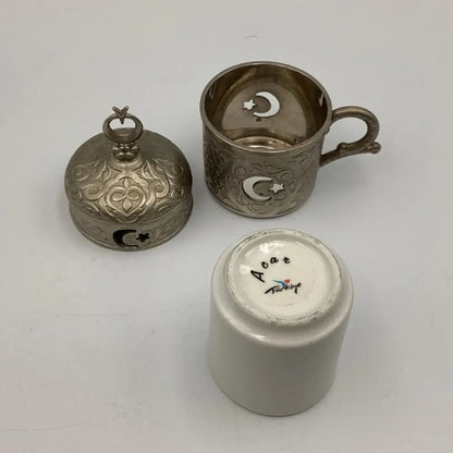 Three metallic items with star and crescent designs 