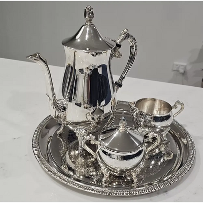 Silver tea set with teapot, creamer, sugar bowl, and tray 