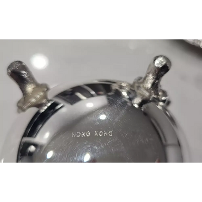 Close-up of a metallic object with 'Hong Kong' engraved on it