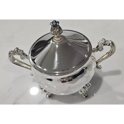 Silver sugar bowl with decorative handles and lid