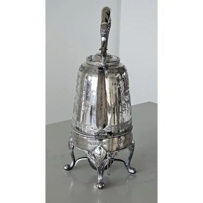 Silver teapot on a reflective surface
