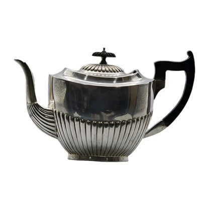 Silver teapot with black handles