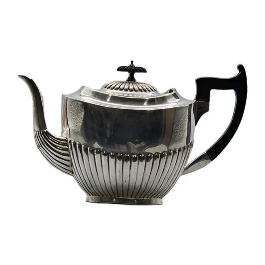 Silver teapot with black handles