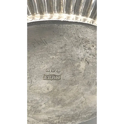 Close-up of a silver object with visible hallmarks