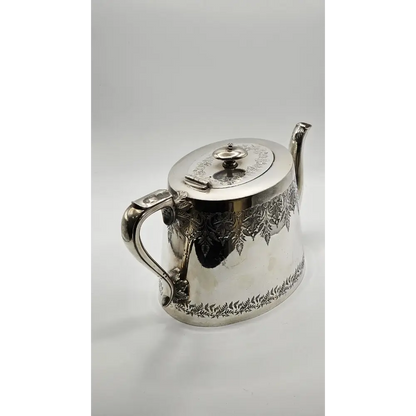 Silver teapot with intricate designs