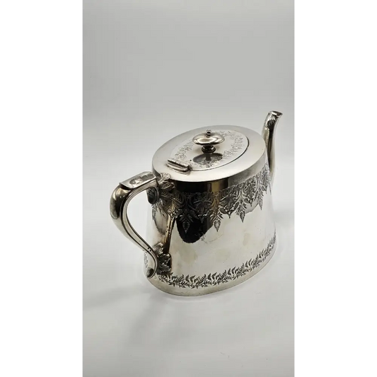 Silver teapot with intricate designs