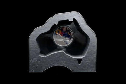 A silver-colored commemorative coin displayed in a custom-shaped metallic holder from our World & Vintage Coins collection