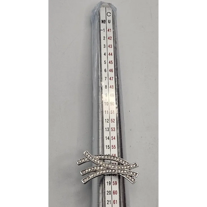 Silver brooch with gemstones on a gray background