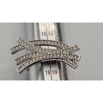 Silver ring with diamond accents on a metal surface